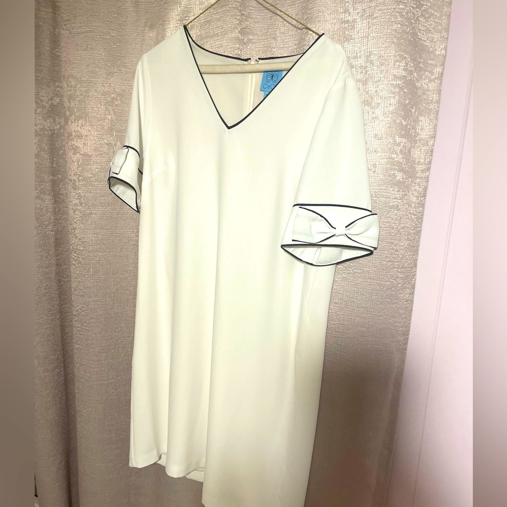 CeCe M white dress with beautiful black lining detail and bow sleeves